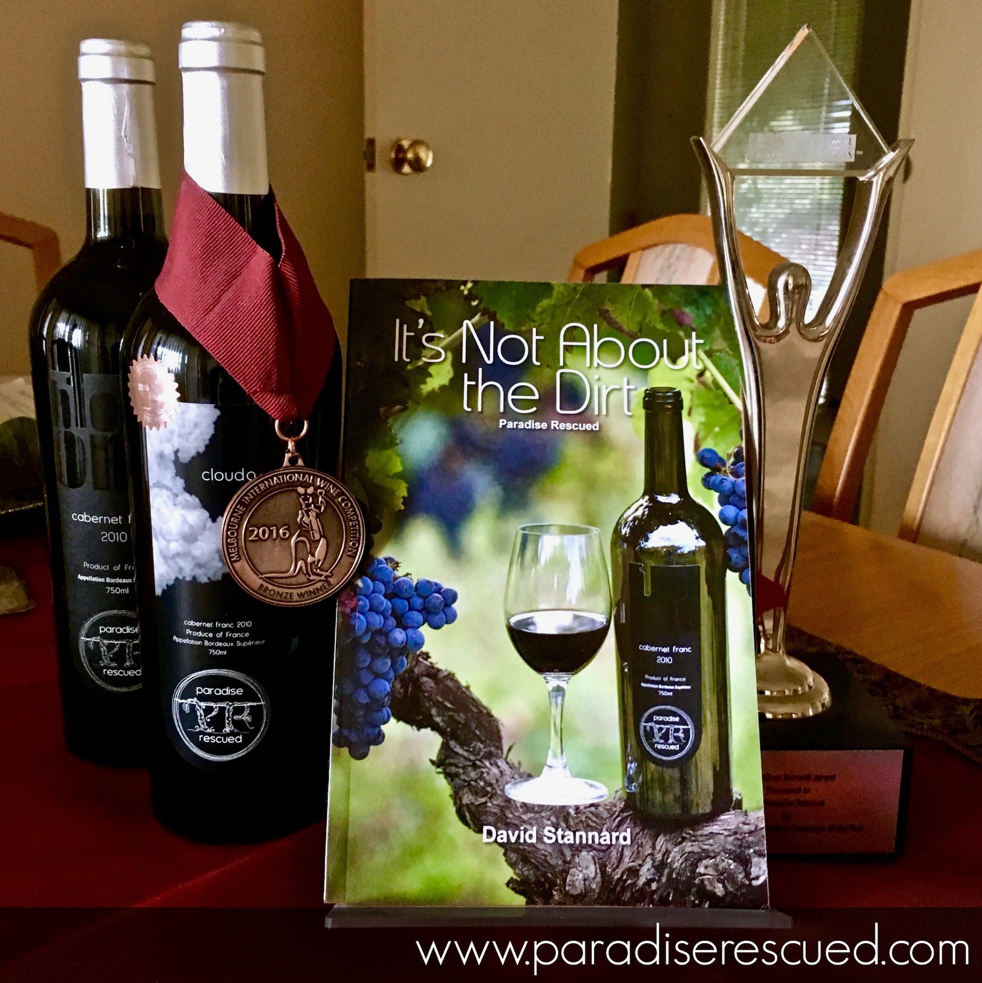 Paradise Rescued book, medal winning wine and international business award.